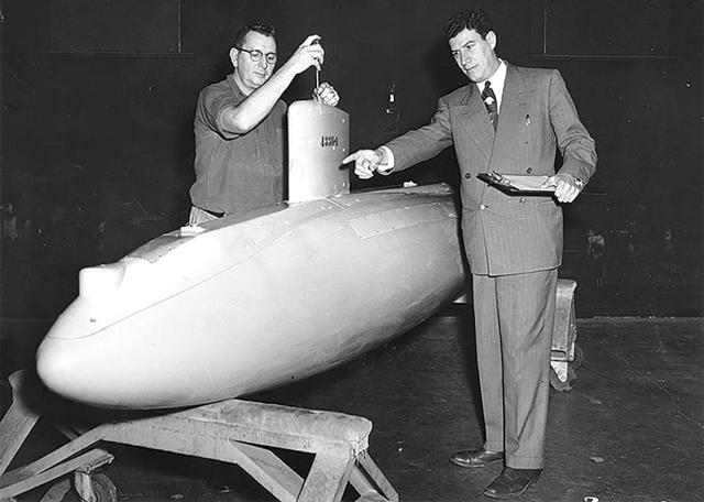 Naval architect Morton Gertler directs instrument maker Carson W. Caudle in preparing a model of the Albacore 